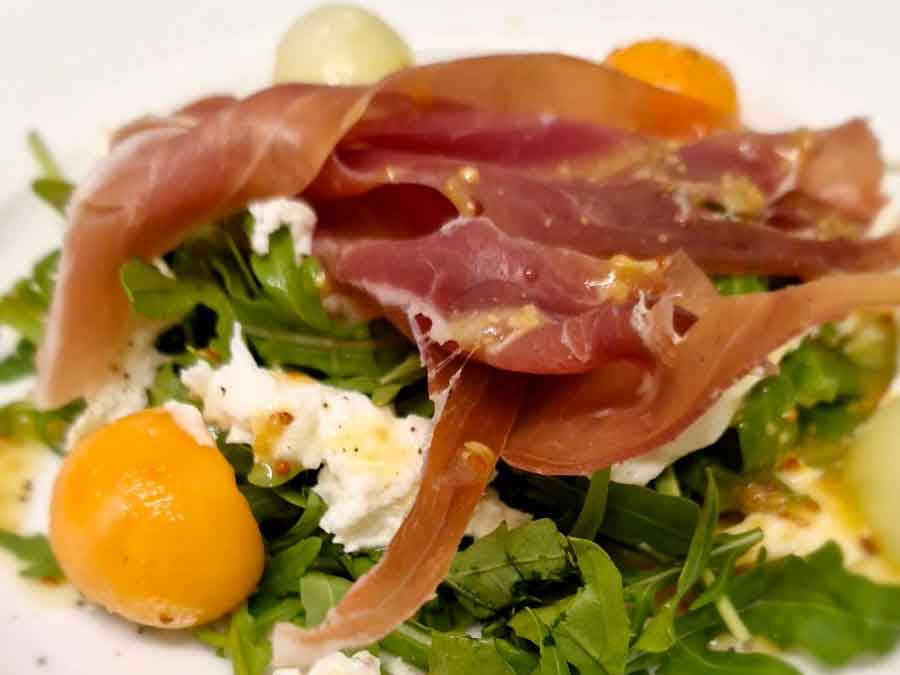 Melon with Parma ham & buffalo mozzarella served with rocket & whole grain, honey mustard dressing